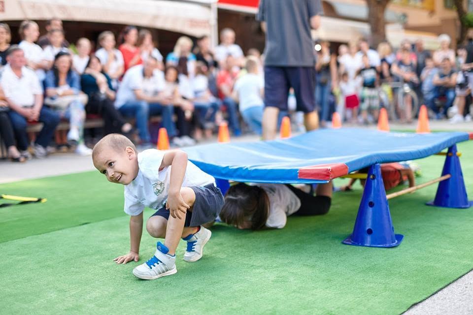 A child taking part in an obstacle course at a club-run family sports day in the town centre